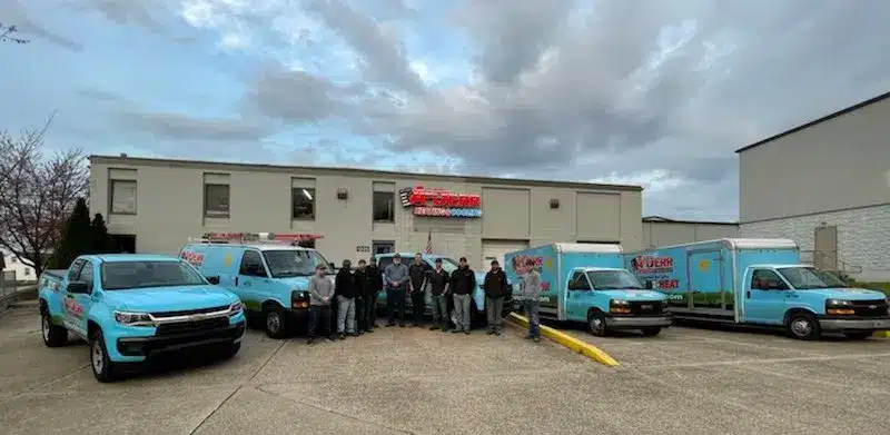 Friendly HVAC service team posing together outside office
