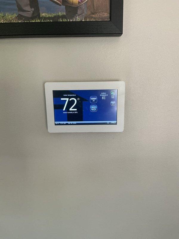 Performed comprehensive system evaluation for HVAC replacement estimate. Assessed existing outdoor condensing unit positioned on concrete pad against building exterior, noting current equipment configuration with refrigerant lines running through brick wall to indoor components. Evaluated indoor climate control system including digital programmable thermostat currently maintaining 72° setpoint with outdoor ambient temperature at 81°. Documented electrical disconnect location and overall system layout. Provided customer with detailed replacement options for complete HVAC system upgrade to improve efficiency and performance.