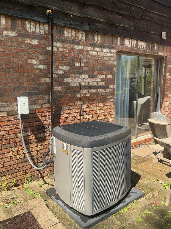 Performed comprehensive system evaluation for HVAC replacement estimate. Assessed existing outdoor condensing unit positioned on concrete pad against building exterior, noting current equipment configuration with refrigerant lines running through brick wall to indoor components. Evaluated indoor climate control system including digital programmable thermostat currently maintaining 72° setpoint with outdoor ambient temperature at 81°. Documented electrical disconnect location and overall system layout. Provided customer with detailed replacement options for complete HVAC system upgrade to improve efficiency and performance.