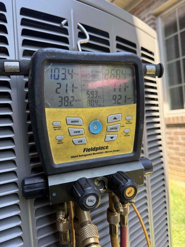 # Complete HVAC System Installation

Installed a complete 5-ton, 18 SEER, 99% AFUE GREEN heating and cooling system with PureAir air purification and a 2-zone automatic damper system. The installation included indoor air handler with curved black ducting, white PVC condensate drainage system, and outdoor condensing unit with proper refrigerant charging verified using digital manifold gauges. System was evacuated, charged to manufacturer specifications, and tested for proper operation across both zones with all safety controls and air quality components functioning as designed.