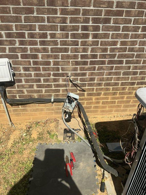 Responded to service call for central air conditioning system not cooling properly with frozen refrigerant line. Upon arrival, found 10-15 year old system with suction line freeze-up at exterior wall penetration. Performed diagnostic assessment of condensing unit and indoor air handler, inspecting electrical connections showing age-related corrosion at junction box and conduit. Evaluated refrigerant charge levels, airflow restrictions, and system operating pressures. Identified low refrigerant charge as primary cause of suction line icing. Recovered remaining refrigerant, performed leak detection on copper line set and coil connections, and repaired identified leak point. Evacuated system to proper vacuum levels, recharged unit to manufacturer specifications, and verified proper superheat and subcooling readings. Completed full preventative maintenance service including filter replacement, coil cleaning, condensate drain clearing, and electrical connection tightening. System restored t