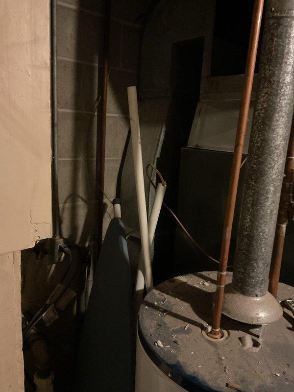 Completed annual maintenance service on 9-year-old system with AprilAire 2400 filter. Inspected mechanical room including water heater, plumbing connections, and ventilation components. Accessed and examined HVAC equipment panels to verify proper installation and condition, noting some minor corrosion on mounting frame that remains within acceptable parameters.