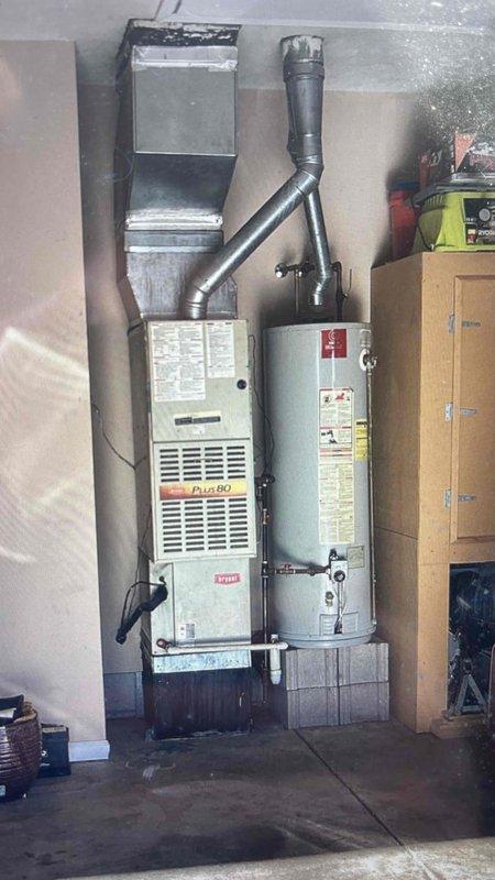 Conducted comprehensive evaluation of HVAC system for replacement estimate, focusing on AC unit with known refrigerant leaks while furnace remains operational. Documentation included detailed measurements of downflow system configuration showing furnace, coil, and base dimensions, with particular attention to ceiling clearances and base condition for proper replacement specifications.