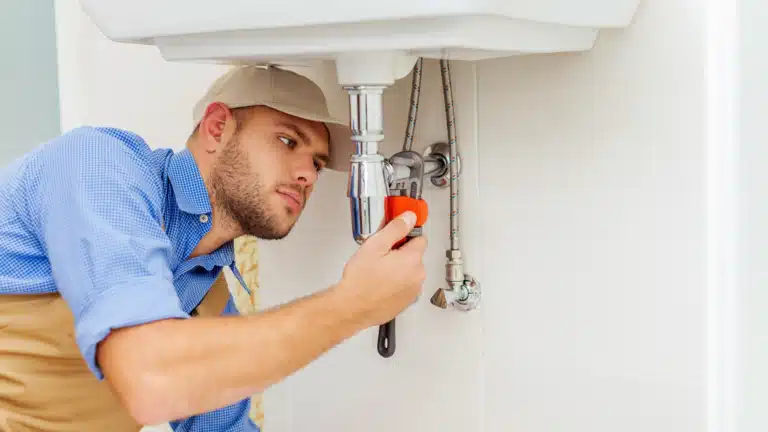 Plumber working on pipes