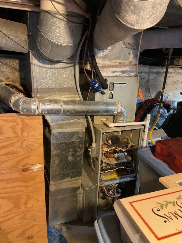 Inspected 13+ year old HVAC system that was blowing cold air instead of heat. Visual examination of the furnace revealed significant age-related wear on internal components, control board, and wiring. System requires full replacement due to deterioration of critical components and inefficient operation.