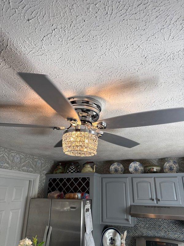 Shelbyville, KY - Installed new ceiling fan with integrated chandelier-style light fixture in kitchen. Mounted unit to ceiling electrical box, secured fan blades, and connected decorative crystal bead light shade. Verified proper operation of fan motor and lighting, ensured stable mounting and balanced rotation.