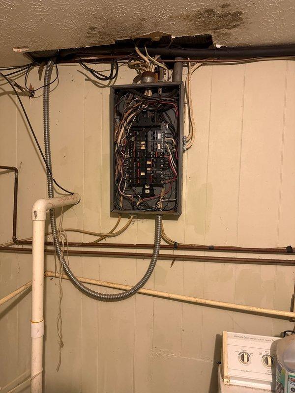 Completed comprehensive electrical estimate for main service panel replacement at residential property. Exterior assessment revealed aging meter base assembly with weathered conduit connections and deteriorated siding conditions requiring consideration during installation. Interior evaluation documented existing panel configuration with multiple circuit breakers, bundled wire connections, and proximity to plumbing infrastructure including copper pipes and PVC conduit that will need accommodation during panel upgrade. Photographed current service equipment conditions including exterior meter socket, weatherhead connections, and interior panel accessibility to provide accurate scope for complete main electrical service replacement.