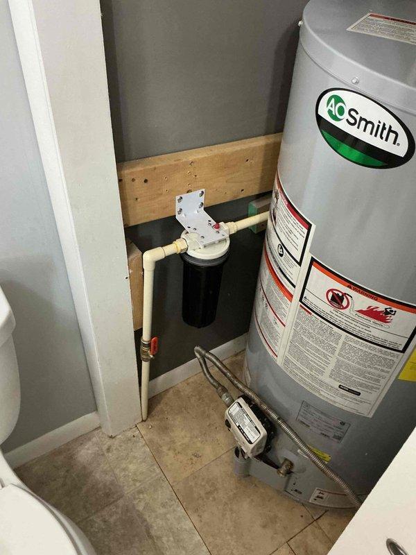 Inspected A.O. Smith water heater system and identified need for shut-off valve replacement and filter installation. Documented existing filtration system and provided customer with quote for water softener as requested. Parts have been ordered with customer preferring installation during warmer weather; scheduled follow-up to install polarized filter and perform duct cleaning during next AC maintenance visit.