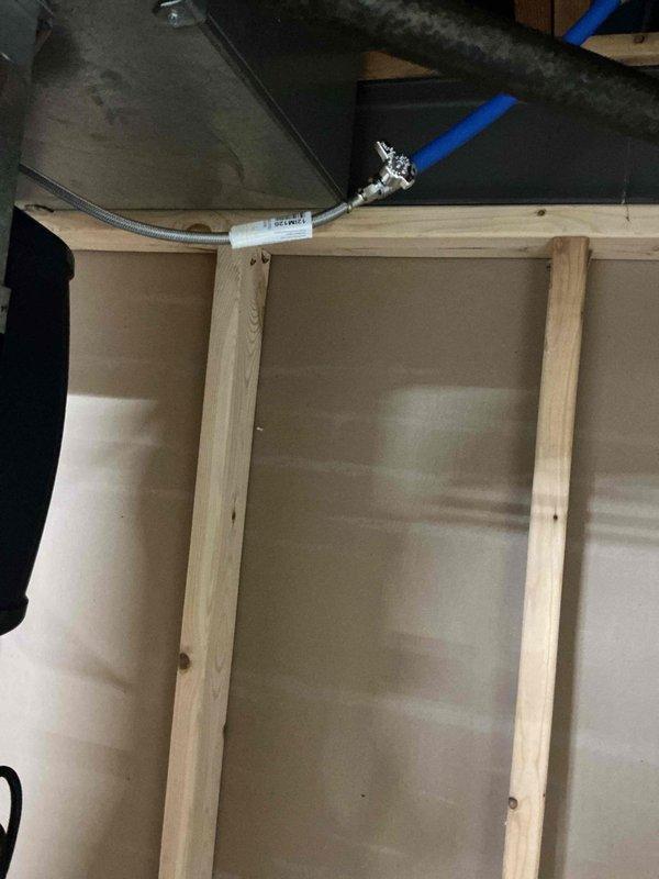 Successfully completed installation of a humidifier, connecting the water supply line to the existing plumbing system. Installed a quarter-turn shut-off valve with braided stainless steel supply line and secured proper connection of blue flexible feed line to the humidifier unit. All connections were tested and verified for proper operation with no leaks.