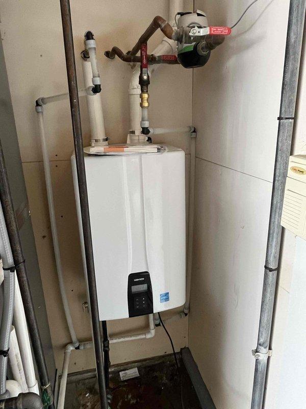 Santa Claus, IN - Successfully completed installation of a tankless water heater system in utility closet. Installation included proper mounting of unit to wall, connection of copper supply lines with shut-off valves, and installation of PVC venting. All connections were tested and system is functioning optimally.