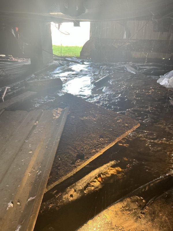 Responded to emergency call for water discharge at rear of mobile home. Upon inspection, located source approximately 4-5 feet beneath structure in crawlspace. Main drain line had separated at elbow connection where pipe transitions to ground level, causing active water flow into crawlspace area. Extensive moisture saturation and standing water observed throughout confined area beneath mobile home. Documented existing conditions with photographs showing compromised drainage system, waterlogged surfaces, and deteriorated crawlspace environment. Advised property owner of findings and provided assessment of repair requirements for disconnected drain line connection.