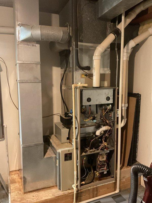Completed comprehensive estimate for full HVAC system replacement on residential property with over 15-year-old equipment. Evaluated existing furnace and air conditioning system in utility room where blower motor had failed due to improperly wired ecobee thermostat causing continuous operation. Assessed current equipment configuration including ductwork connections, PVC venting, and electrical wiring to determine replacement specifications and provided detailed quote for new heating and cooling system installation.