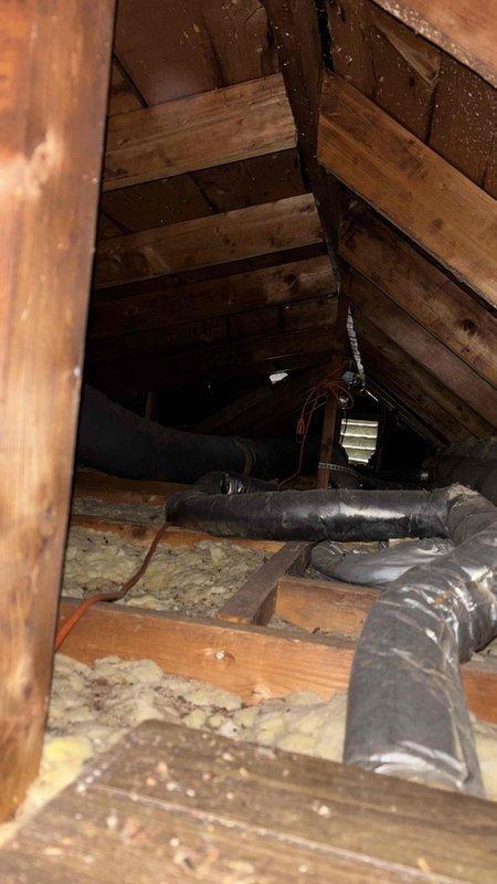 Conducted comprehensive HVAC system evaluation for complete equipment replacement at residential property with non-functional upstairs air conditioning unit and aging outdoor equipment. Assessed attic space containing existing ductwork and insulation conditions, noting flexible duct routing and structural access points for future installation. Evaluated exterior condensing units showing significant rust deterioration and weathering, indicating end-of-service-life conditions requiring replacement. Provided estimates for complete HVAC system upgrade including new heating and cooling equipment, thermostat replacements, and integration solutions to connect upstairs and main level climate control systems into cohesive whole-home comfort solution.