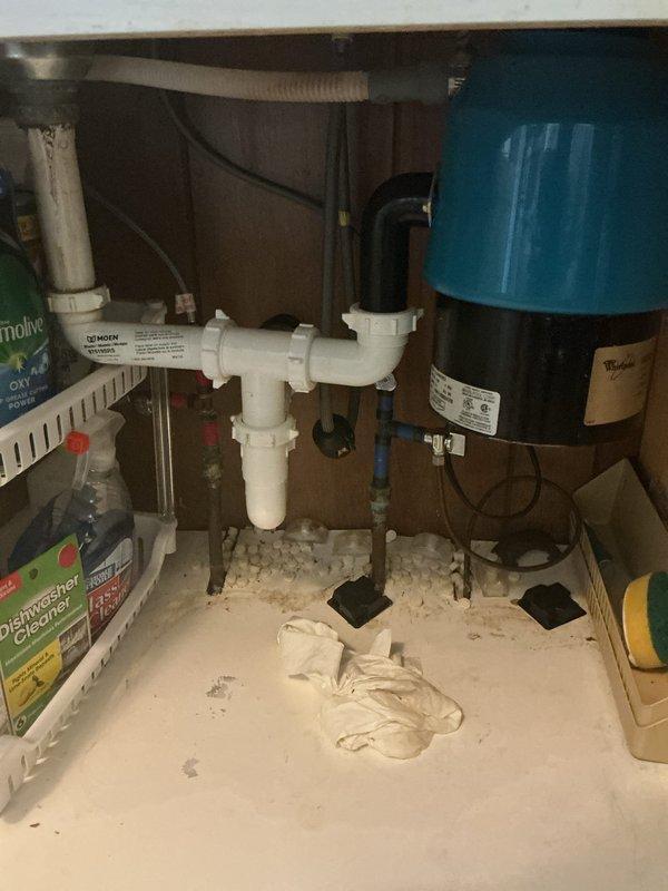 Responded to service call for leaking garbage disposal with water accumulation under sink. Upon inspection, identified active leak at disposal unit causing water damage to cabinet floor. Removed and replaced faulty garbage disposal unit, reconnected drain lines to existing P-trap assembly, and verified proper seal at all connection points. Tested system for leaks, confirmed proper drainage, and cleaned work area.