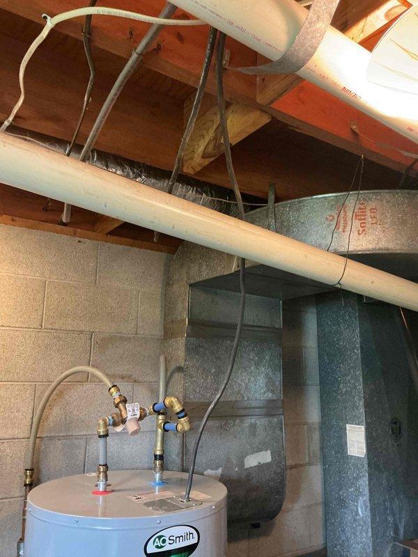 Completed on-site plumbing estimate for electric water heater replacement and laundry room reconfiguration. Evaluated existing 50-gallon electric AO Smith tank water heater located in basement utility area and assessed feasibility of converting to tankless electric system. Provided estimate options for both tank and tankless configurations, including necessary electrical upgrades, venting modifications, and code compliance requirements. Assessed additional scope for relocating washer supply hoses and drain lines in same area as water heater to optimize laundry room layout. Documented existing plumbing connections, electrical service capacity, available space constraints, and structural considerations for equipment placement. Photographed current installation including water heater, supply and discharge piping, electrical connections, surrounding mechanical systems, and proposed work areas. Reviewed with homeowner the advantages and disadvantages of tank versus tankless systems, includi