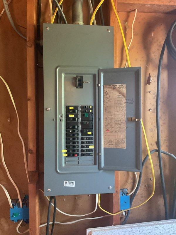 Evaluated residential electrical infrastructure to determine capacity and requirements for proposed ductless mini-split installation in bedroom area. Assessed existing electrical panel, circuit breaker configuration, and available amperage to support additional HVAC load. Photographed panel layout showing current circuit distribution, breaker ratings, and available spaces for dedicated mini-split circuit installation to provide independent cooling zone as requested.