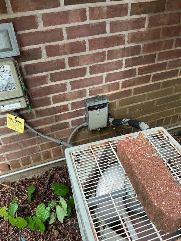 Responded to service call for HVAC system failing to cool effectively, with thermostat set to 70 degrees while indoor temperature reached 80 degrees. Upon arrival, conducted diagnostic evaluation of split system consisting of Amana furnace with air handler and outdoor condensing unit. Customer reported compressor producing humming sound with condenser fan failing to operate.

Performed comprehensive system inspection revealing outdoor condensing unit exhibiting advanced corrosion and deterioration on exterior casing, indicating significant age and exposure damage. Diagnosed failed condenser fan motor preventing proper heat rejection and airflow across condenser coil. Compressor attempting to operate but unable to function efficiently without proper ventilation and cooling from fan operation. Verified electrical connections at disconnect box and confirmed no tripped breakers or power supply issues.

Given the extensive rust damage to outdoor unit cabinet, age of existing Amana equipment