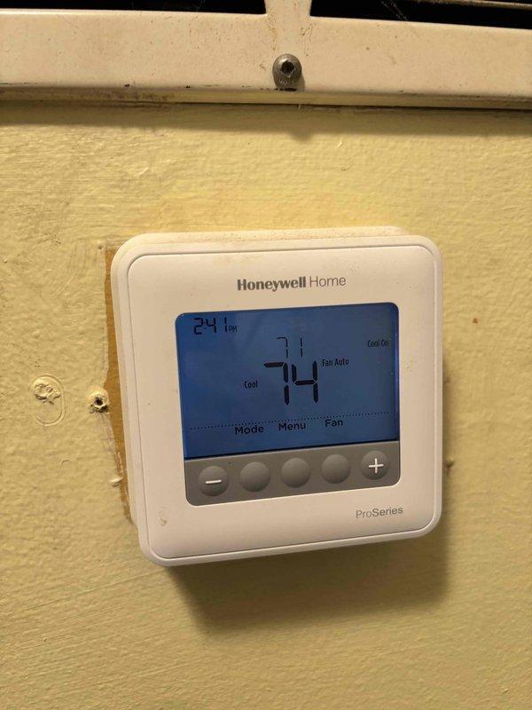Completed planned HVAC maintenance tune-up on residential cooling system as part of member servicing program. Performed standard preventive maintenance procedures including system inspection, temperature verification at thermostat showing 74°F cooling setpoint with 71.5°F ambient reading at outdoor unit, and documented equipment operation with Honeywell Home ProSeries thermostat functioning properly in automatic fan mode. System operating within normal parameters upon completion.