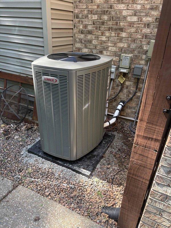 Completed full HVAC system installation including new Lennox outdoor condensing unit and associated ductwork. Unit was properly positioned on rubber isolation pad over gravel base for drainage and vibration dampening. Connected refrigerant lines with insulated piping, secured all connections to exterior wall with appropriate mounting brackets, and installed electrical disconnects and control boxes per manufacturer specifications. Verified system operation with temperature readings confirming proper heat output at 714°F at the heating elements. All components tested and functioning within normal parameters.