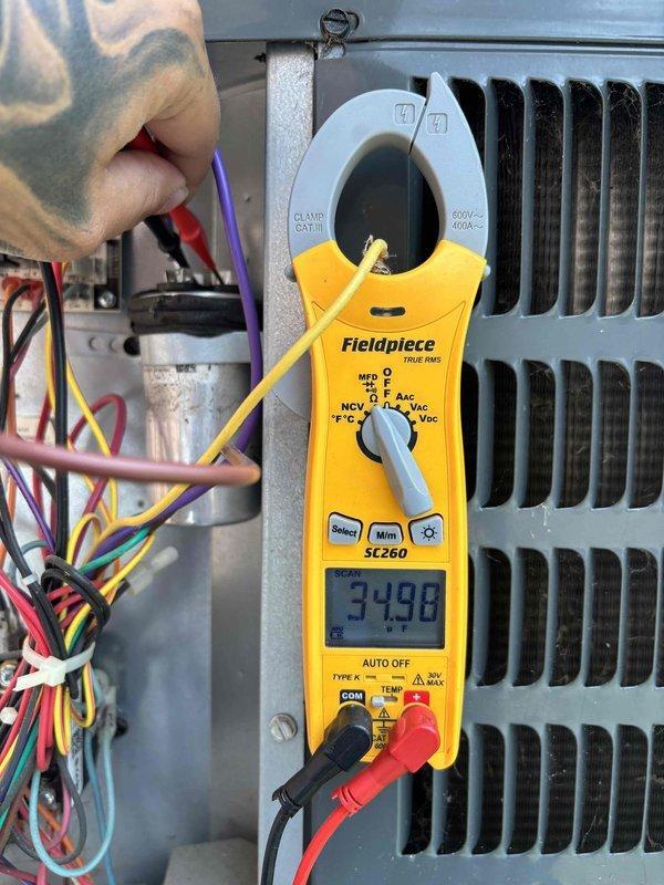 Completed complimentary HVAC system maintenance as requested via scheduled appointment. System was reported as currently operating properly upon arrival. Performed comprehensive tune-up service including electrical diagnostics using clamp meter to verify amperage readings on system components. Measured and documented electrical current draw, recording readings of 86.0 and 34.98 amps at various points in the system to ensure proper operation within manufacturer specifications. Inspected all electrical connections, wiring bundles, and terminal points for secure connections and proper condition. Examined refrigerant lines with foam insulation for integrity and proper installation. Verified condenser coil fins and heat exchanger components for cleanliness and proper airflow. System tested and confirmed to be functioning within normal operating parameters with no issues identified requiring immediate attention.