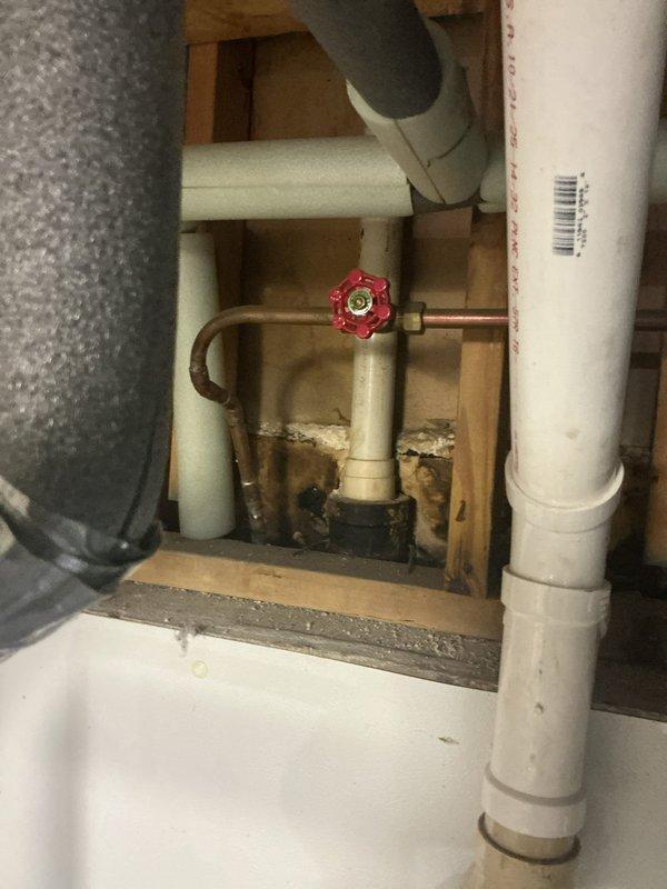 Completed routine USA Bronze Tanked Maintenance inspection of residential plumbing system in basement utility area. Documented existing moisture infiltration issues along concrete foundation walls and floor, noting water staining patterns and surface deterioration. Inspected copper supply lines with shut-off valves, PVC drainage piping, and associated connections for proper operation and structural integrity, with all components functioning within normal parameters at time of visit.