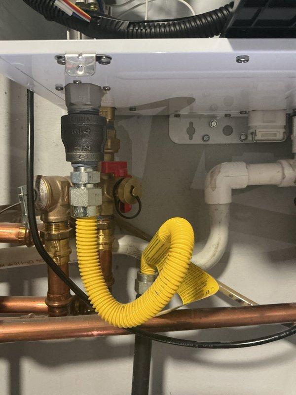 Responded to ignition failure on water heater less than one year old. Upon inspection, identified improper installation of gas line, plumbing connections, and condensate line requiring complete system reconfiguration. Performed initial diagnostic assessment and manometer reading test to verify gas pressure and system functionality. Scheduled return visit to completely redo all plumbing connections, gas line installation, and condensate drainage system to meet code requirements and manufacturer specifications. System restored to operational status with proper ignition function confirmed. Customer payment collected in full with zero balance remaining.