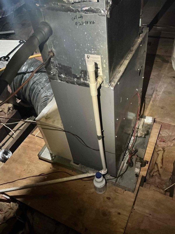 Conducted comprehensive HVAC replacement estimate for aging system showing significant deterioration, including discolored and peeling cabinet surfaces, worn components, and visible accumulation of debris. Evaluated both indoor air handler unit located in basement utility area on wooden platform and outdoor condenser unit positioned on concrete pad, documenting existing equipment condition, ductwork connections, electrical service, refrigerant line routing, and condensate drainage configuration to provide homeowner with complete system replacement options.