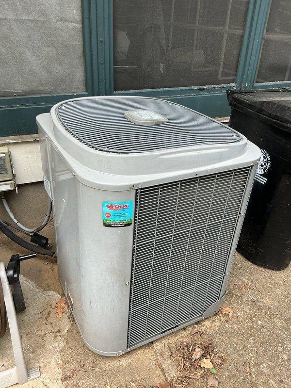 Conducted comprehensive HVAC replacement estimate for aging system showing significant deterioration, including discolored and peeling cabinet surfaces, worn components, and visible accumulation of debris. Evaluated both indoor air handler unit located in basement utility area on wooden platform and outdoor condenser unit positioned on concrete pad, documenting existing equipment condition, ductwork connections, electrical service, refrigerant line routing, and condensate drainage configuration to provide homeowner with complete system replacement options.