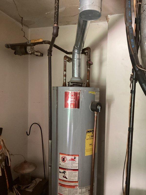 Santa Claus, IN - Responded to emergency call for leaking 30-gallon gas water heater. Upon arrival, water supply had been shut off to stop active leak. Performed comprehensive assessment of existing tanked water heater, documenting unit condition, age indicators, copper supply line connections, gas venting configuration, and overall installation setup. Provided professional estimate for water heater replacement options and discussed solutions with homeowner present during consultation.