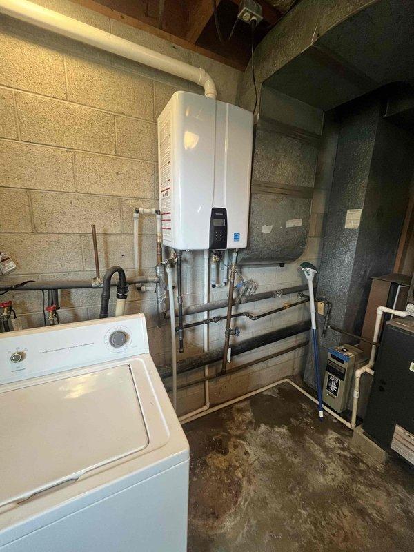 Grayville, IL - Installed a new 180 BTU tankless water heater unit in basement utility room, mounting the unit to concrete block wall and connecting all necessary copper and PEX supply lines along with proper venting system. Completed full plumbing integration with existing washing machine and HVAC system, ensuring all connections meet code requirements and optimal water flow throughout the residence.