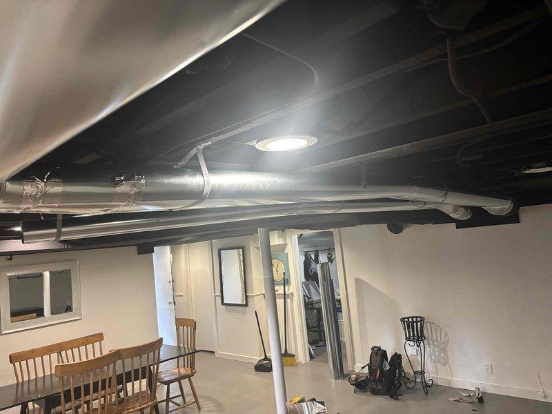 Completed installation of HVAC ductwork in basement and attic spaces. Installed rigid metallic ductwork in finished basement area with proper support strapping and secured flexible aluminum ductwork in attic cavity with appropriate fastening and metallic tape at connection points. All ductwork properly positioned and secured to ensure optimal airflow and system performance.