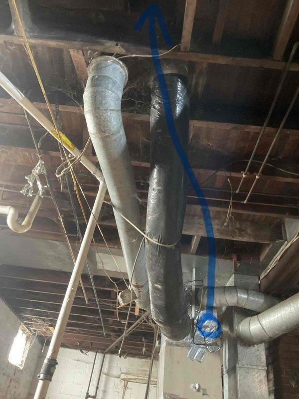 Conducted comprehensive ductwork assessment in unfinished basement utility space to evaluate existing HVAC distribution system and provide estimate for replacement. Documented current ductwork configuration including large cylindrical insulated supply trunk, metallic flex connections, and rigid metal branch ducts running through exposed floor joists. Identified aged galvanized metal ductwork with flexible ribbed connections showing signs of deterioration, dust accumulation, and potential air leakage points at seams and joints. Evaluated structural clearances, existing routing pathways, and accessibility for new ductwork installation throughout the mechanical space.