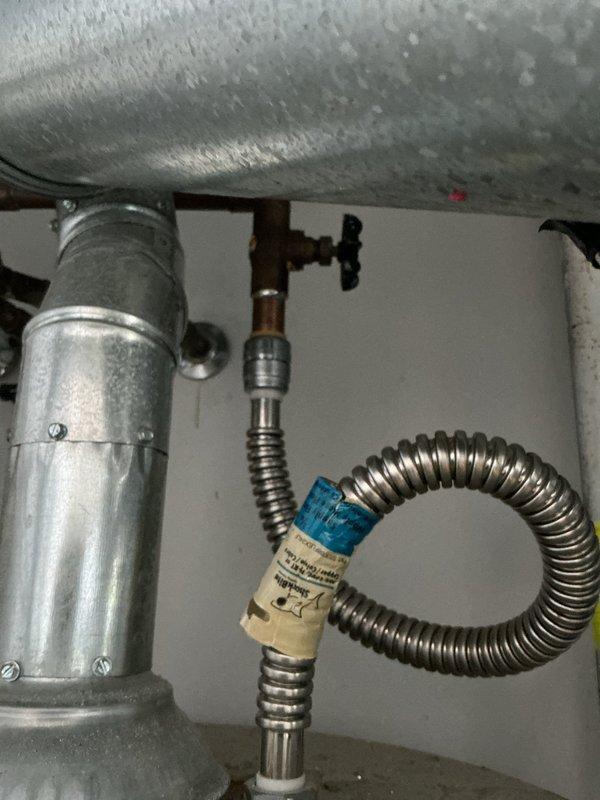 Performed preventative maintenance service on tank-style water heater as part of scheduled maintenance plan. Inspected all plumbing connections, shut-off valves, and flex connectors for proper operation and signs of wear. Observed significant condensation on tank exterior, indicating normal temperature differential between cold water supply and ambient conditions. Verified copper supply lines, brass fittings, and corrugated stainless steel flex line connections for leaks and proper installation. All components found to be functioning within normal parameters with no immediate repairs required.
