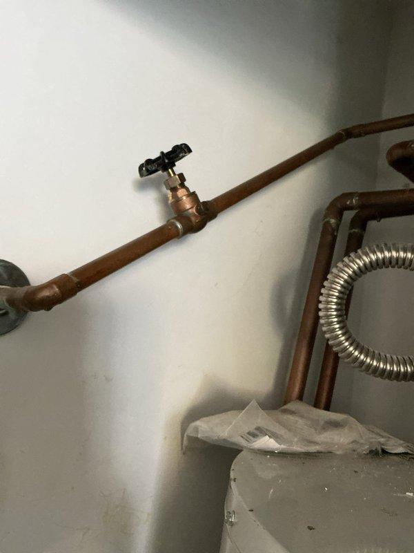 Performed preventative maintenance service on tank-style water heater as part of scheduled maintenance plan. Inspected all plumbing connections, shut-off valves, and flex connectors for proper operation and signs of wear. Observed significant condensation on tank exterior, indicating normal temperature differential between cold water supply and ambient conditions. Verified copper supply lines, brass fittings, and corrugated stainless steel flex line connections for leaks and proper installation. All components found to be functioning within normal parameters with no immediate repairs required.
