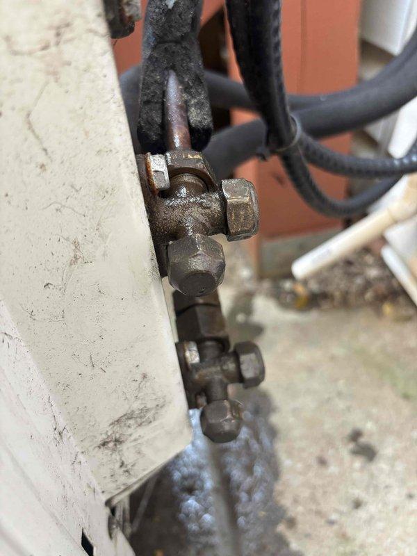 Conducted follow-up site visit to document and assess incomplete HVAC installation work. Performed visual inspection and photographed mechanical connections, pipe fittings, and conduit assemblies showing evidence of weathering, corrosion on brass fittings, and aging components requiring attention before project completion.
